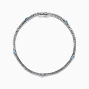 The Lab Grown Blue and White Diamond Tennis Station Bracelet in 14K white gold features clear lab grown diamonds with three evenly spaced round blue gemstones, shown displayed on a white background.