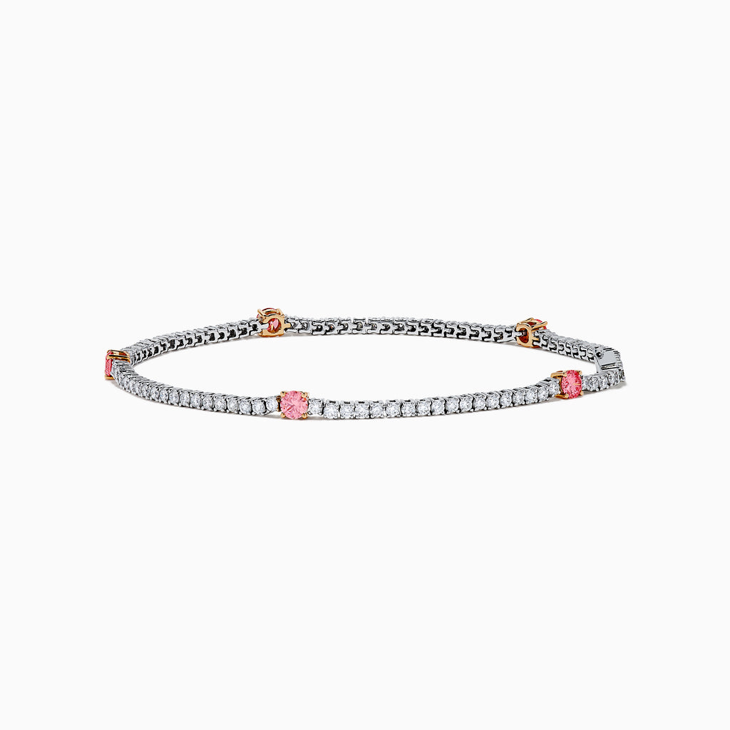 The Lab Grown Pink and White Diamond Tennis Station Bracelet in 14K White Gold features a slim band with sparkling clear stones and three larger pink and white diamonds in rose gold accents, beautifully displayed on a white background.