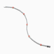 The Lab Grown Pink and White Diamond Tennis Station Bracelet in 14K White Gold features a slim band with sparkling clear stones and three larger pink and white diamonds in rose gold accents, beautifully displayed on a white background.