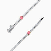 The Lab Grown Pink and White Diamond Tennis Station Bracelet in 14K White Gold features a slim band with sparkling clear stones and three larger pink and white diamonds in rose gold accents, beautifully displayed on a white background.