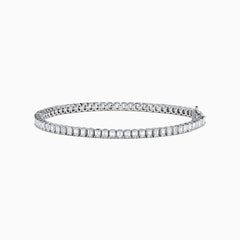 The Lab Grown Emerald Cut Diamond 4.26ct Tennis Bracelet in 14K White Gold features a single row of lab grown diamonds, set in a sleek white gold band and showcased on a plain white background.
