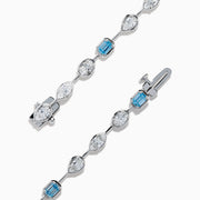 The Lab Grown Blue and White Diamond Multi Shape Tennis Bracelet in 14K White Gold showcases alternating oval, round, and emerald-cut lab-grown blue and white diamonds against a white background.