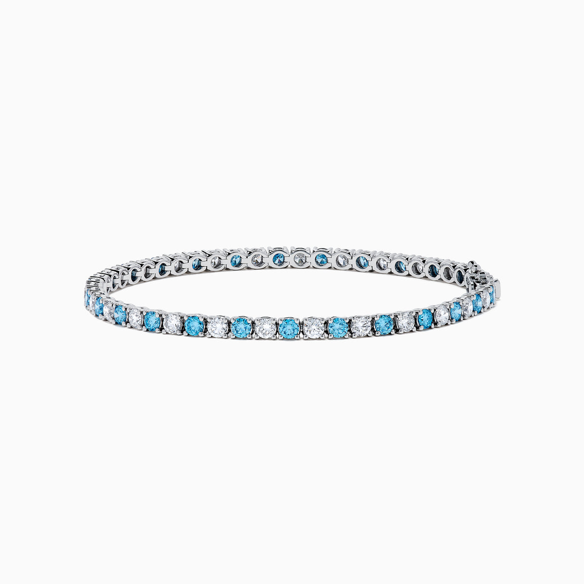 The Lab Grown Blue and White Diamond Tennis Bracelet in 14K White Gold features alternating round blue and white diamonds set in a continuous line, shown against a white background.