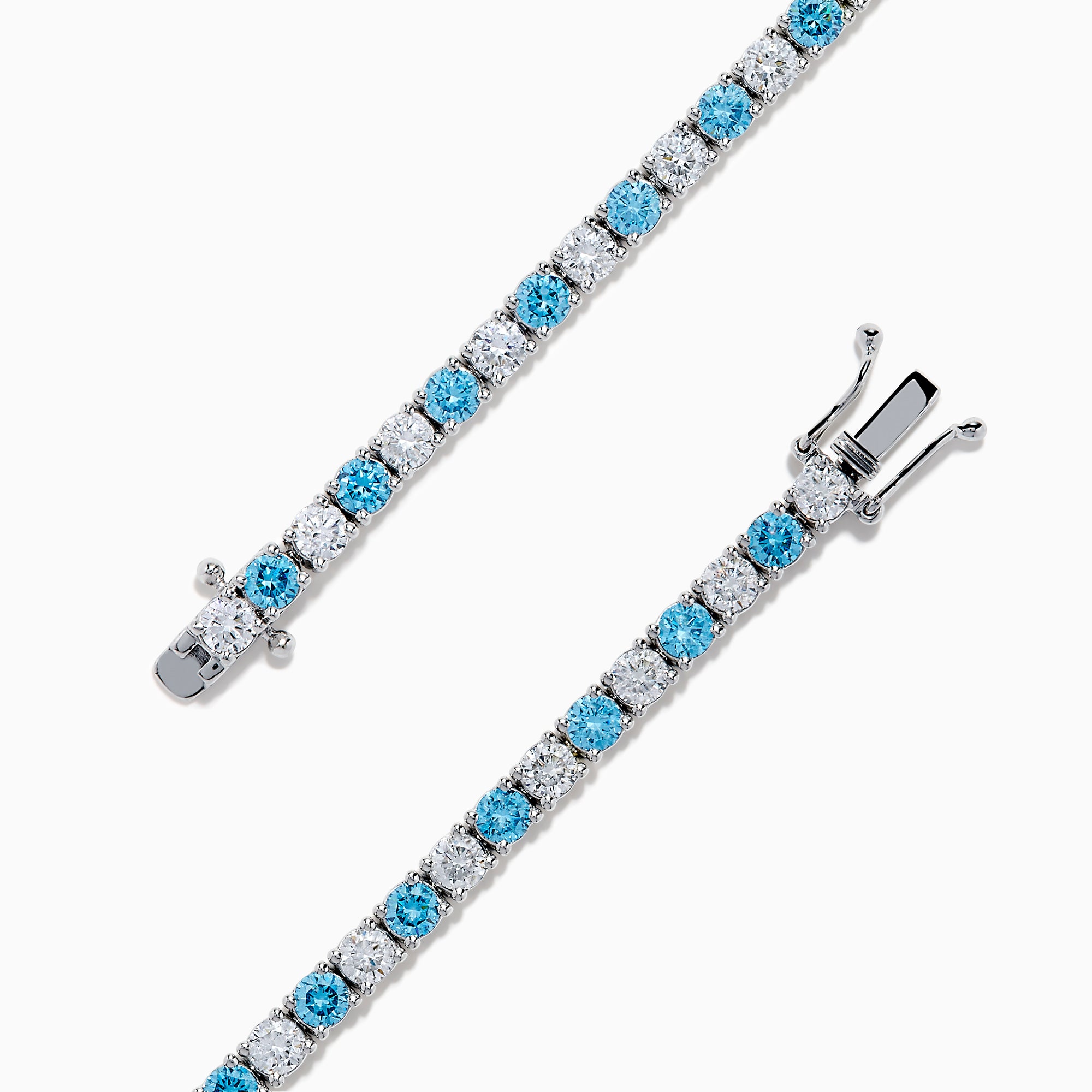 The Lab Grown Blue and White Diamond Tennis Bracelet in 14K White Gold features alternating round blue and white diamonds set in a continuous line, shown against a white background.