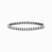 The 925 Sterling Silver Diamond Tennis Bracelet showcases a row of round-cut diamonds set in sleek sterling silver, elegantly displayed against a white background.