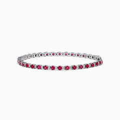 The 925 Sterling Silver Ruby and Diamond Tennis Bracelet features a continuous row of round rubies and diamonds set in individual prongs, forming an elegant circle for timeless sophistication.