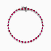 The 925 Sterling Silver Ruby and Diamond Tennis Bracelet features a continuous row of round rubies and diamonds set in individual prongs, forming an elegant circle for timeless sophistication.