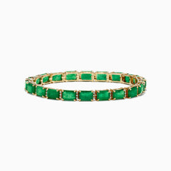The Brasilica 14K Yellow Gold Emerald and Diamond Tennis Bracelet showcases a row of rectangular emeralds and sparkling diamonds set in prongs, forming an elegant, continuous design against a plain white background.