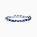 The Nahla 925 Silver Tanzanite and Diamond Tennis Bracelet showcases rectangular tanzanite gemstones and sparkling diamonds set in a graceful, continuous design.