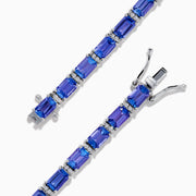 The Nahla 925 Silver Tanzanite and Diamond Tennis Bracelet showcases rectangular tanzanite gemstones and sparkling diamonds set in a graceful, continuous design.