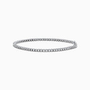 The 14K White Gold Diamond Tennis Bracelet 0.98 TCW features a slender band adorned with a continuous line of sparkling diamonds, beautifully displayed on a white background.