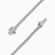 The 14K White Gold Diamond Tennis Bracelet 0.98 TCW features a slender band adorned with a continuous line of sparkling diamonds, beautifully displayed on a white background.