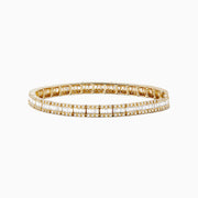 The Classique 14k Yellow Gold Diamond Tennis Bracelet features two rows of sparkling diamonds totaling 2.65 TCW, reminiscent of a classic tennis bracelet, beautifully displayed against a white background.
