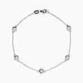 The 14K White Gold Bezel Diamond Bezel Bracelet features five round diamond-like stones in bezel settings, evenly spaced along a delicate chain, and secured with a lobster clasp.
