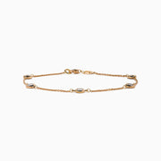 The Pave Rose 14K Rose Gold Diamond Station Bracelet features five round diamonds in gold bezels on a delicate chain with a lobster clasp, shown on a white background.