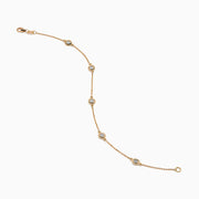 The Pave Rose 14K Rose Gold Diamond Station Bracelet features five evenly spaced round diamond settings and a clasp closure, elegantly displayed on a white background.
