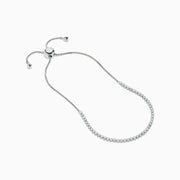 The 14K White Gold Pave Diamond Bolo Bracelet features a row of sparkling diamonds and a sliding clasp, elegantly displayed on a white background.