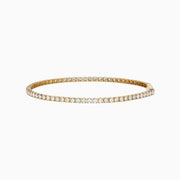 The 14K Yellow Gold Diamond Tennis Bracelet 2.33TCW, featuring a continuous row of sparkling round white diamonds, is elegantly shown on a simple white background.