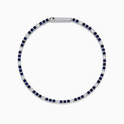 The Royale Bleu 14K White Gold Tennis Bracelet features alternating round blue sapphires and diamonds set in a slim band with a simple clasp, shown on a white background.