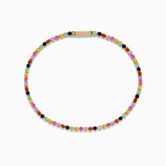 The Watercolors 14K Yellow Gold Multi Sapphire Tennis Bracelet features a single row of small, round, multicolored sapphires in a repeating pattern, displayed on a white background.