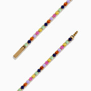 The Watercolors 14K Yellow Gold Multi Sapphire Tennis Bracelet features a single row of small, round, multicolored sapphires in a repeating pattern, displayed on a white background.