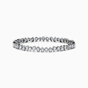 The 14K White Gold Fancy Cut Diamond Miracle Set Bracelet features alternating oval, pear, and emerald-cut diamonds in a continuous pattern against a white gold background.