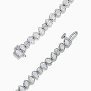 The 14K White Gold Fancy Cut Diamond Miracle Set Bracelet features alternating oval, pear, and emerald-cut diamonds in a continuous pattern against a white gold background.