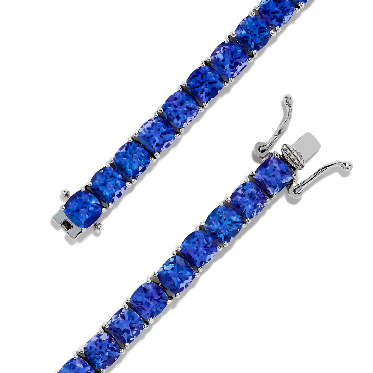 The Nahla Siri Sterling Silver Tanzanite Tennis Bracelet showcases a row of square-cut tanzanite gemstones set evenly around the band, displayed against a white background.