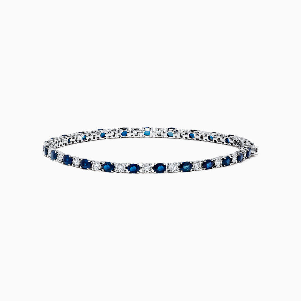 The Royale Bleu 14k White Gold Blue Sapphire and Diamond Bracelet showcases alternating round blue sapphires and clear diamonds in a continuous line, beautifully set against a plain white background.