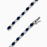 The Royale Bleu 14k White Gold Blue Sapphire and Diamond Bracelet showcases alternating round blue sapphires and clear diamonds in a continuous line, beautifully set against a plain white background.