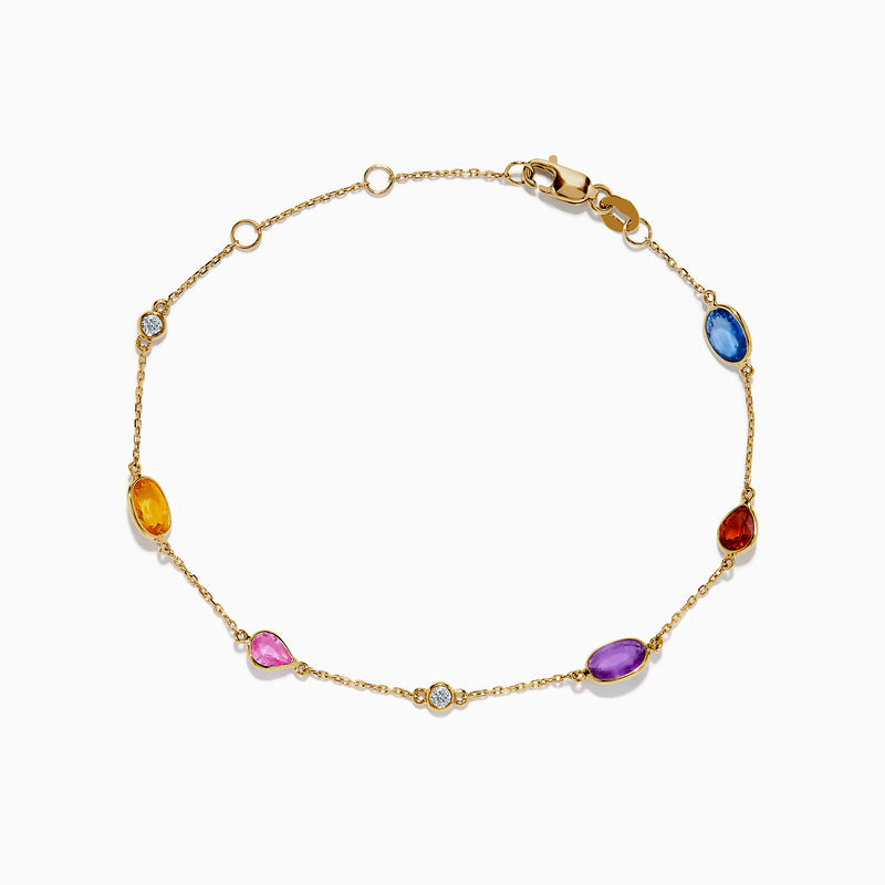 The 14K Yellow Gold Multi Color Sapphire and Diamond Station Bracelet features oval sapphires in blue, pink, purple, orange, and red with sparkling diamonds on a delicate chain and secures with a lobster clasp.
