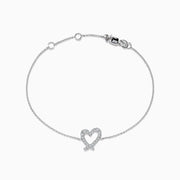 The Novelty 14K White Gold Heart Bracelet features a thin chain, a diamond-accented heart centerpiece, and a secure lobster clasp closure.