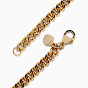 The Mens 14K Yellow Gold Chain Bracelet 8.25 features a chunky curb link design and a small round charm near the clasp, shown against a white background.
