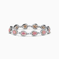 The 18K Two-Tone Gold Pink and White Diamond Tennis Bracelet features alternating teardrop-shaped settings with pink and white diamonds accented by small clear stones, shown on a white background.