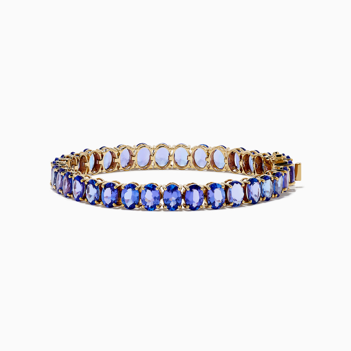 The Nahla Siri 14K Yellow Gold Tanzanite Tennis Bracelet showcases a continuous row of oval-cut blue gemstones set closely together for an elegant look.