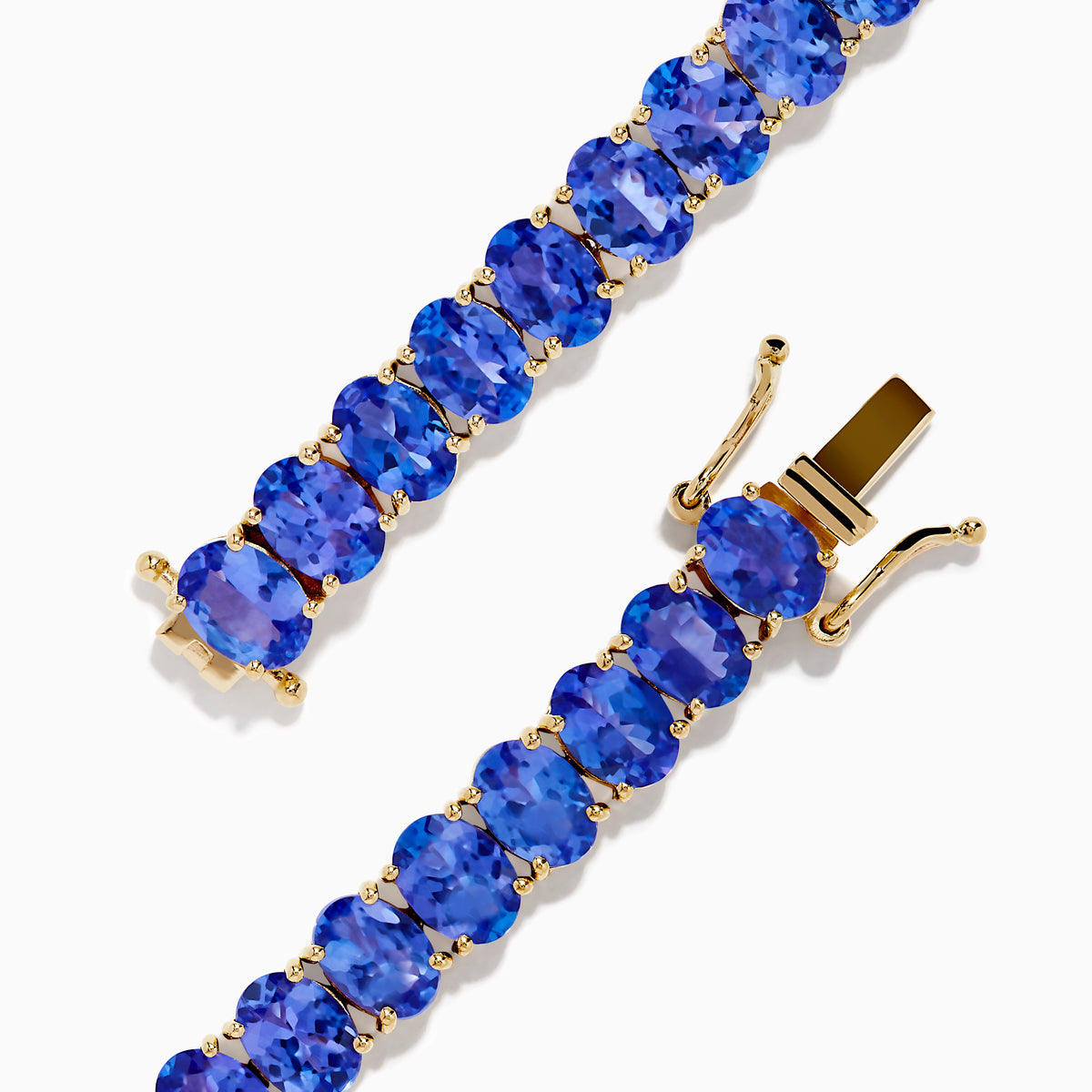 The Nahla Siri 14K Yellow Gold Tanzanite Tennis Bracelet showcases a continuous row of oval-cut blue gemstones set closely together for an elegant look.