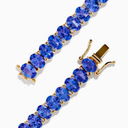 The Nahla Siri 14K Yellow Gold Tanzanite Tennis Bracelet showcases a continuous row of oval-cut blue gemstones set closely together for an elegant look.