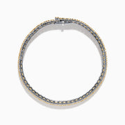 The Canare 18K Two Tone Gold White & Yellow Diamond Bracelet, showcasing a central row of yellow diamonds bordered by clear stones, is elegantly displayed on a white background.