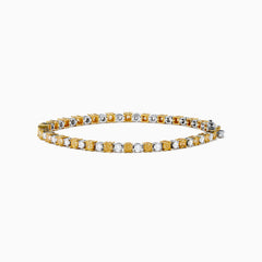 The Canare 18K White and Yellow Gold Diamond Tennis Bracelet features alternating white and yellow diamonds, elegantly displayed in a circular shape on a white background.