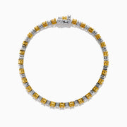 The Canare 18K White and Yellow Gold Diamond Tennis Bracelet features alternating white and yellow diamonds, elegantly displayed in a circular shape on a white background.