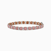 The 18K Two Tone White & Pink Diamond Bracelet features alternating clusters of pink and white diamonds in a repeating pattern around the entire band, beautifully set against a white background.