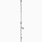 The 14K White Gold Diamond Station Bracelet features small round and teardrop-shaped diamonds spaced along a thin chain, showcased on a white background.
