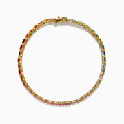 The Watercolors 14K Yellow Gold Multi Sapphire Oval Tennis Bracelet features a gradient rainbow of oval sapphires, smoothly transitioning in color from red and orange to yellow, green, blue, and purple.