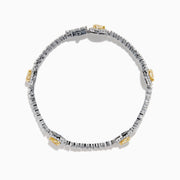 The 18K Two Tone Gold Yellow and White Diamond Station Tennis Bracelet features sparkling white diamonds and three striking yellow and white diamond stations, each outlined by smaller diamonds in an elegant, detailed design.