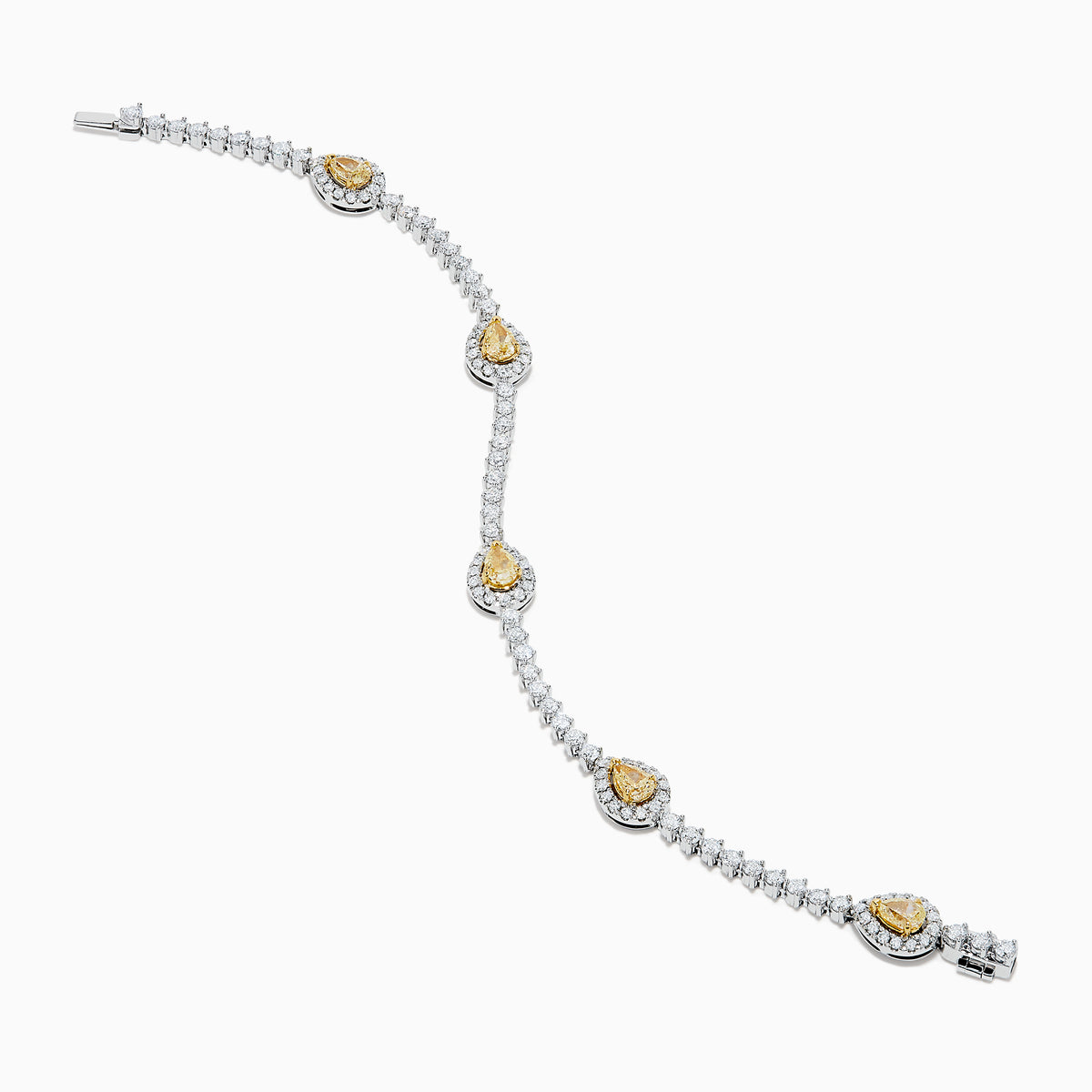 The 18K Two Tone Gold Yellow and White Diamond Station Tennis Bracelet features sparkling white diamonds and three striking yellow and white diamond stations, each outlined by smaller diamonds in an elegant, detailed design.
