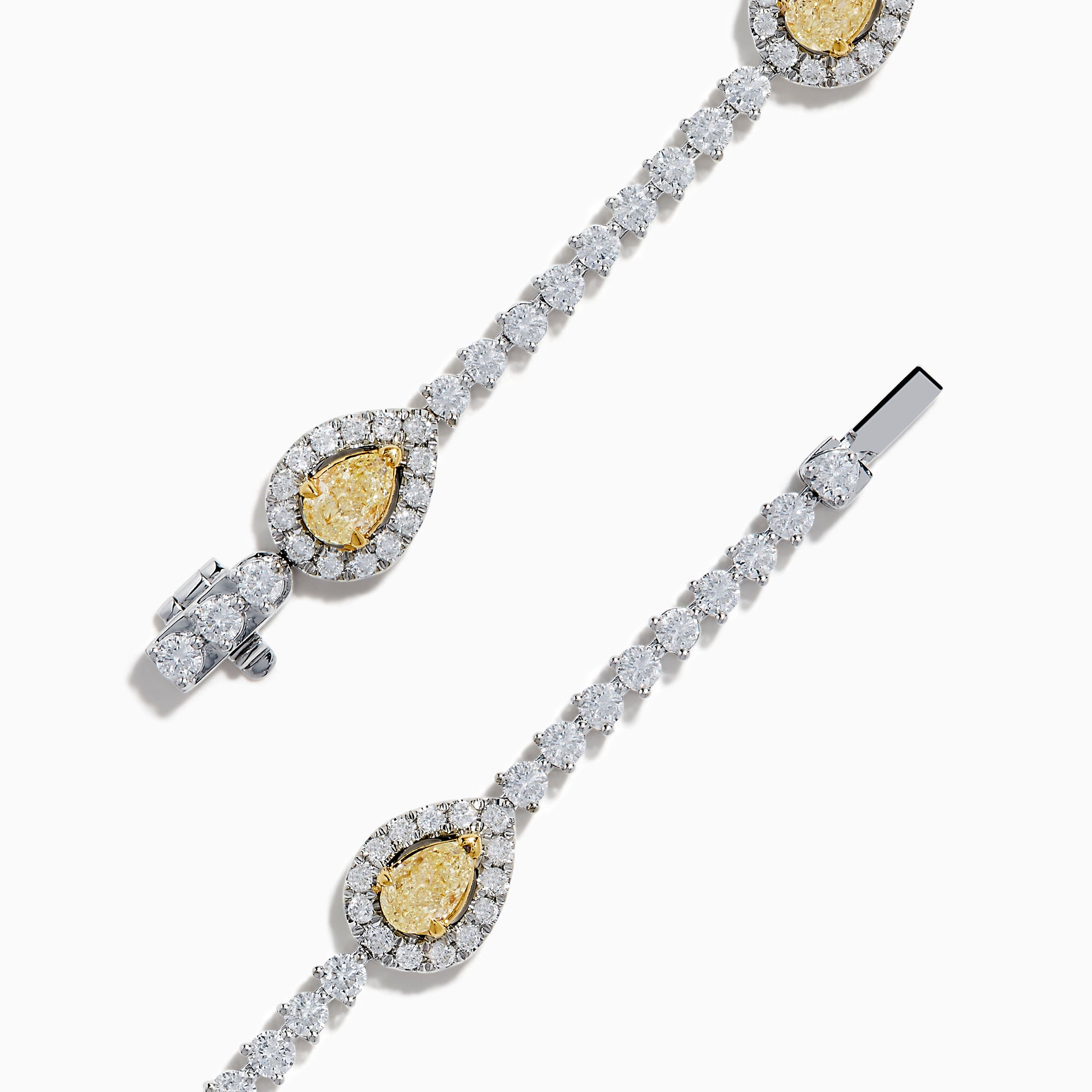 The 18K Two Tone Gold Yellow and White Diamond Station Tennis Bracelet features sparkling white diamonds and three striking yellow and white diamond stations, each outlined by smaller diamonds in an elegant, detailed design.