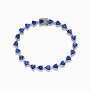 The Nahla Siri Sterling Silver Tanzanite and Diamond Tennis Bracelet features triangular blue gemstones and diamonds set in sterling silver, evenly spaced and connected, shown against a white background.