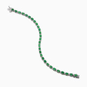 The 925 Sterling Silver Emerald and Diamond Tennis Bracelet features a continuous row of oval green gemstones and diamonds, each prong-set for elegance, reminiscent of an emerald bracelet, displayed on a white background.