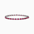 The 925 Sterling Silver Ruby and Diamond Tennis Bracelet features a continuous row of round rubies and diamonds in prong settings, elegantly displayed in a circular shape against a white background.