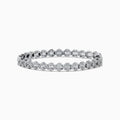 The 925 Sterling Silver Diamond Cluster Tennis Bracelet showcases two rows of round, sparkling diamonds in a repeating cluster pattern, displayed on a white background.